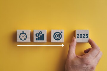 Wooden blocks with icons representing time, progress, and targets leading to 2025.