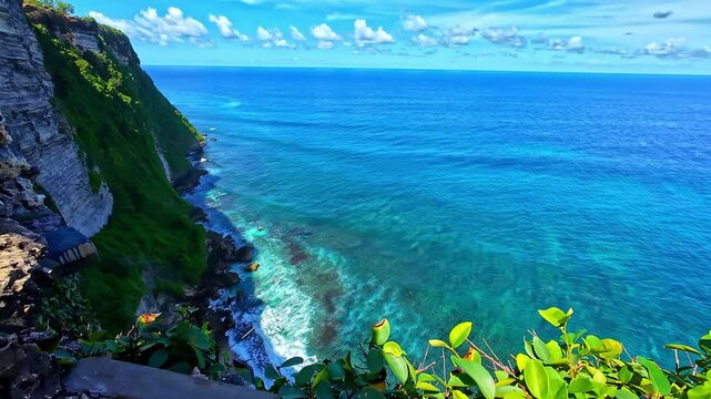Clear view of the turquoise ocean meeting lush green cliffs at Pura Luhur, Bali