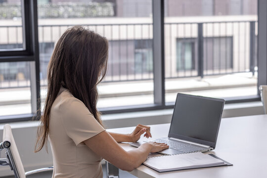 Businesswoman working on a laptop in modern office