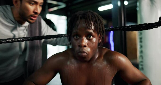 Man, boxer and rest with coach in boxing ring for motivation, coaching advice and tips of tournament. Male person, instructor and physical assessment of fight, competition plan and recovery for match