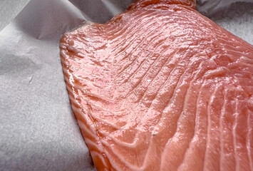 Raw salmon fillet ready for baking, fresh seafood prepared for healthy cooking, concept of nutritious marine food and culinary preparation