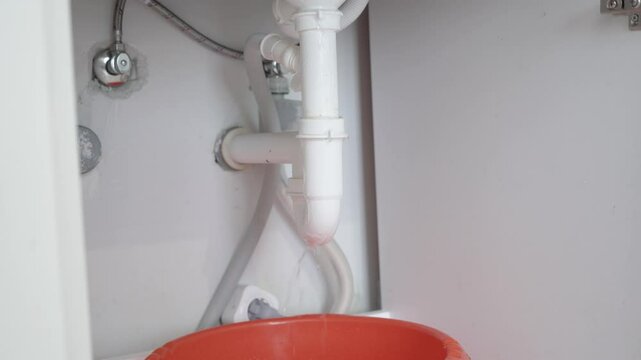 blocked kitchen sink where water fails to drain, slowly flooding the sink bowl and spilling out.