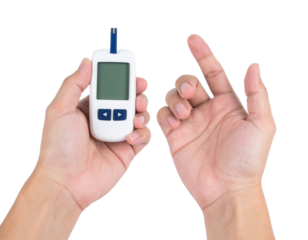 A person holds a blood glucose meter with one hand while the other hand is positioned for a finger prick test.