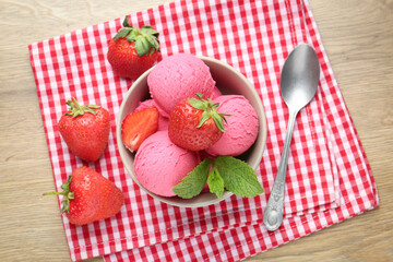 Refreshing sorbet, strawberries and mint on wooden table, top view