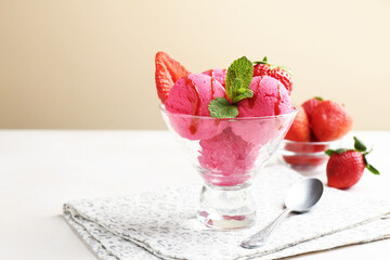 Refreshing sorbet with syrup, strawberries and mint in dessert bowl on white table against beige background, closeup. Space for text