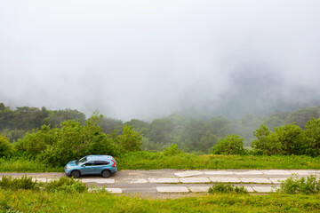 perechyn, ukraine - 22 ju2 2019: 4wd car on a countryside mountain road. family suv for weekend on the hillside. mountain landscape of carpathian alps on a foggy morning in summer. vacation memories