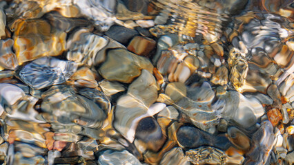 Stones lying on the bottom of the Mediterranean Sea, high detail, summer vacation, travel around Europe
