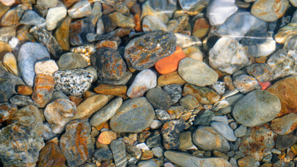 Stones lying on the bottom of the Mediterranean Sea, high detail, summer vacation, travel around Europe