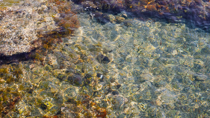 Stones lying on the bottom of the Mediterranean Sea, high detail, summer vacation, travel around Europe