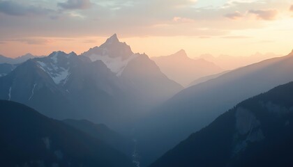 Fototapeta premium Scenic mountain range at sunset with snow-capped peaks and hazy valley