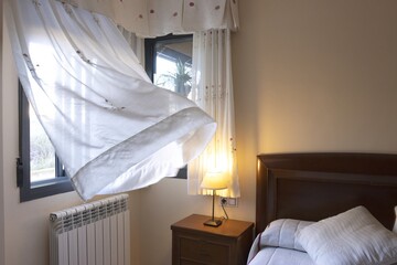 Breeze Blowing Through Open Window in Cozy Bedroom