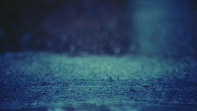 Raindrops fall into submerged roads, and road flooding occurs due to heavy rain in the wet season. Autumn rain falls into a large puddle on the asphalt.