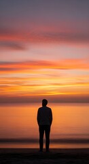 Fototapeta premium Serene Sunset Reflection with a solitary figure overlooking the water