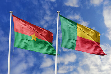 Flags of Burkina Faso and Benin Waving Together Against a Blue Sky, Symbolizing West African...