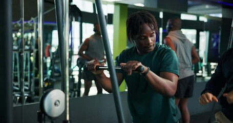 Man, fitness and instructor with demonstration on cable pulley machine for arm exercise or workout. Male people, coach and helping client with training technique for triceps, reps or tips at gym