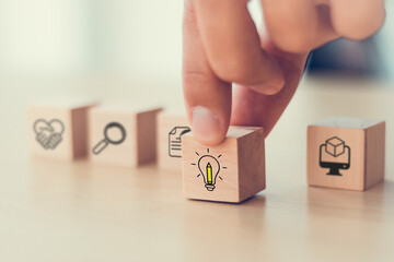 Design Thinking Process concept. Wooden blocks with icons; the key stages of the design thinking process, a solution-focused, problem-solving methodology used for innovation and strategic development.