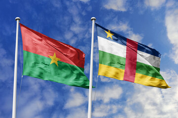 A Burkina Faso and Central African Republic flag, a metaphor for Central African unity, wave together against a blue sky, symbolizing friendship and cooperation.