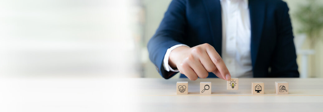 Design Thinking Process concept. Wooden blocks with icons; the key stages of the design thinking process, a solution-focused, problem-solving methodology used for innovation and strategic development.
