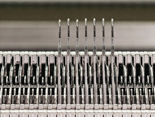 Close-up of a knitting machine needle array.