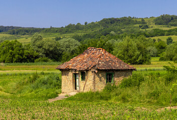 Landscape with an old abandoned house in the countryside