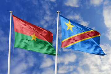 A Burkina Faso and Democratic Republic of the Congo flag, a metaphor for Central African unity, wave together against a blue sky, symbolizing friendship and cooperation.