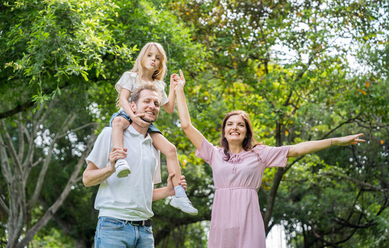 Happy family parent children having picnic outdoor activity. Enjoy happiness moment summer playing together including father mother son and daughter relaxing in the morning sunrise. - Powered by Adobe
