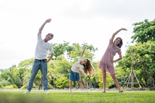 Happy family parent children having picnic outdoor activity. Enjoy happiness moment summer playing together including father mother son and daughter relaxing in the morning sunrise.