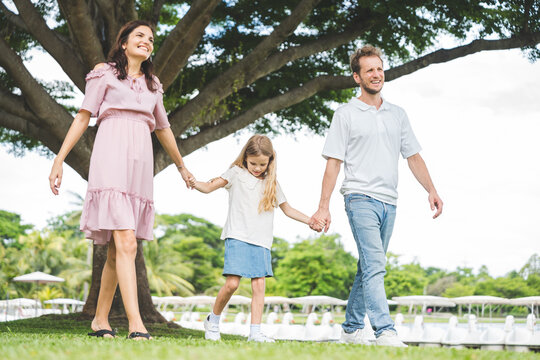 Happy family parent children having picnic outdoor activity. Enjoy happiness moment summer playing together including father mother son and daughter relaxing in the morning sunrise.