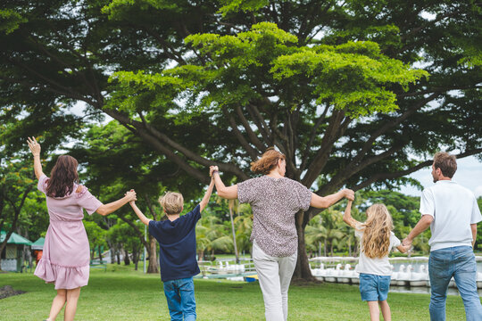 Happy family parent children having picnic outdoor activity. Enjoy happiness moment summer playing together including father mother son and daughter relaxing in the morning sunrise.
