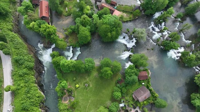 Watermill village Rastoke on rivers Slunj and Korana. Charming village of Rastoke with waterfalls, wooden houses, rivers running through. Aerial view of fairy-tale spring location in heart of Croatia
