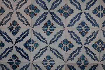 Ottoman ceramic tiles with stylized blue saz leaves and pomegranate-like floral clusters in...