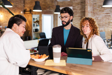 Colleagues collaborating during breaktime in modern office