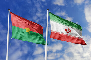Flags of Burkina Faso and Iran Waving Together Against a Blue Sky, Symbolizing Diplomatic Relations and Intercontinental Ties