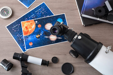 Astronomical study concept with student telescope eyepiece on wooden table