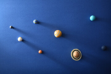 Solar system concept with planets on textured blue cardboard