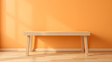 A clean, minimalist wooden table stands against a bright orange wall in a sunlit room.