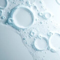 Close-up of translucent, light-blue liquid with varying-sized bubbles, creating a textured, abstract pattern on a pale background