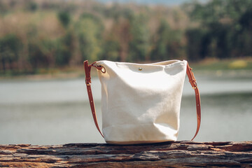 Canvas tote bag on wooden floor at outdoor. Eco friendly and Zero waste concept. Mockup for design.