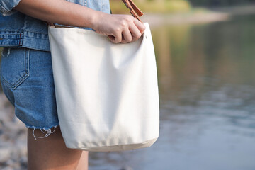 Woman holding canvas tote bag. Eco friendly and Recycling concept. Mockup for design.