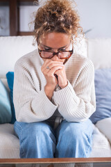 Mature woman feeling sad and overwhelmed at home. Middle-aged female sitting alone with negative...