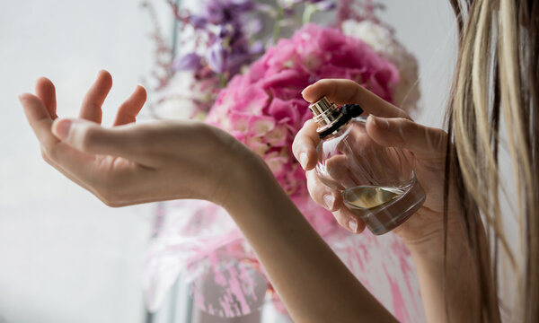 Woman spraying perfume
