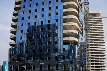Unfinished skyscraper in city.