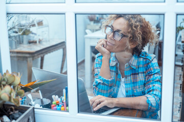Mature woman working remotely from home using laptop computer. Middle-aged freelancer or remote...