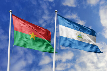 Burkina Faso and Nicaragua flags waving together under a bright sky, symbolizing diplomatic harmony and cultural exchange between nations. A metaphor for global cooperation and peace amidst the clouds