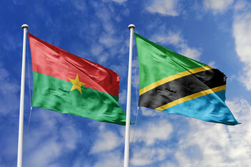 A Burkina Faso and Tanzania flag, a metaphor for East-West African unity, wave together against a blue sky, symbolizing friendship and cooperation.