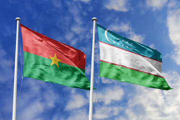A Burkina Faso and Uzbekistan flag, a metaphor for global unity, wave together against a blue sky, symbolizing friendship and cultural diversity.