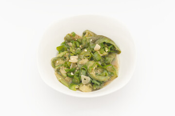 a bowl of green chili pepper fried with green eggplant