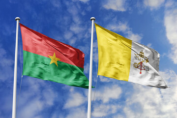 A Burkina Faso and Vatican flag, a metaphor for spiritual and cultural unity, wave together against a blue sky, symbolizing peace and cooperation.