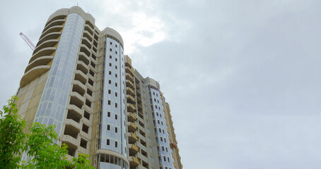Construction of new high-rise buildings against a bright sky