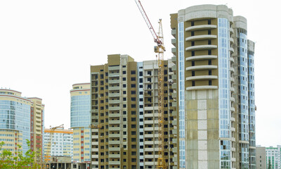 Construction of new high-rise buildings against a bright sky